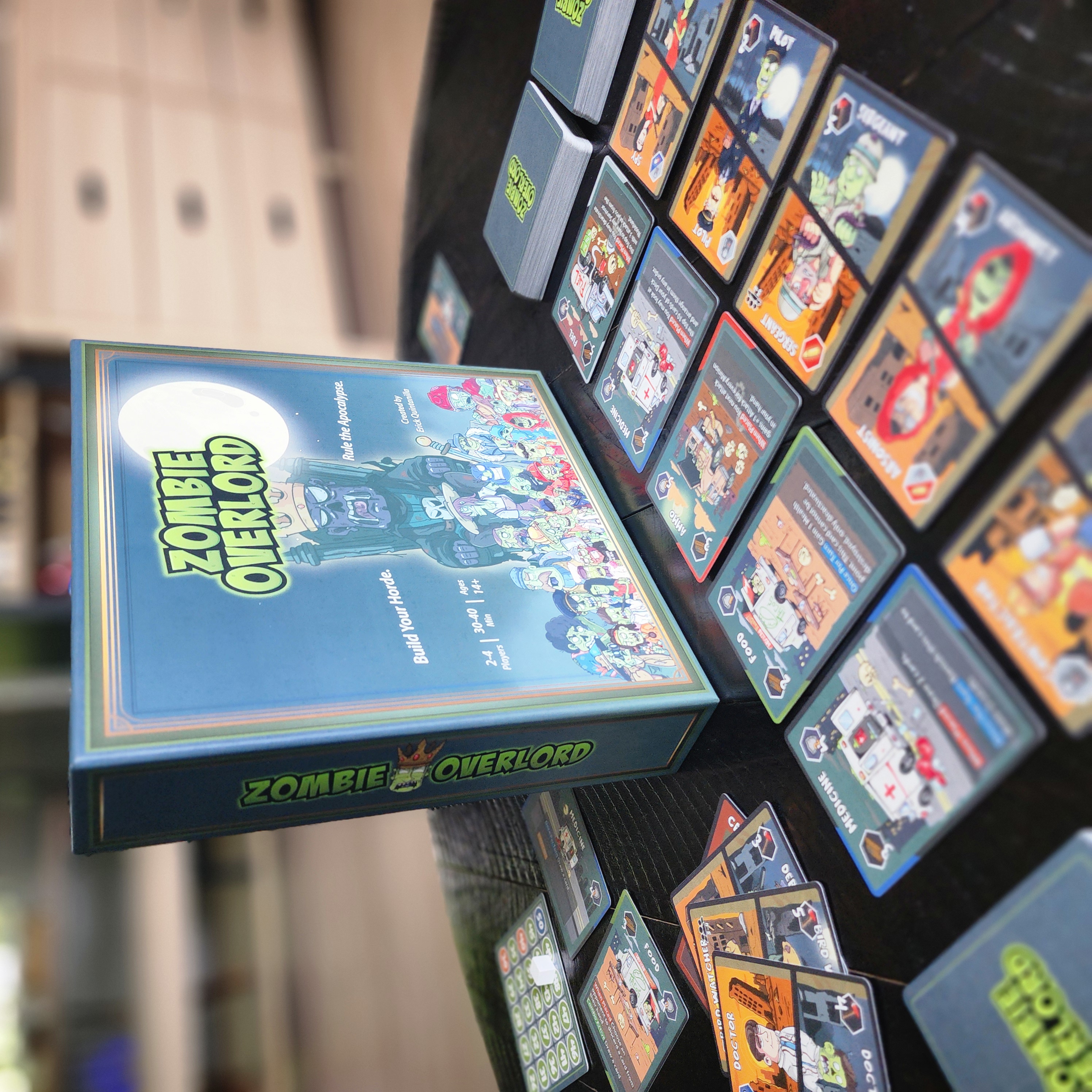 Zombie Overlord game laid out on table showing box and cards